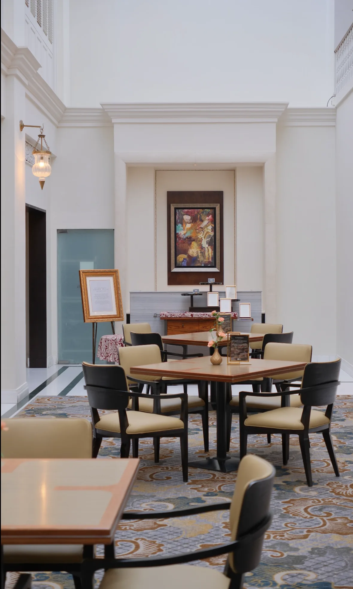 A serviced apartment or hotel lobby interior with high ceilings, the kind of temporary base people land in during their first weeks in Singapore