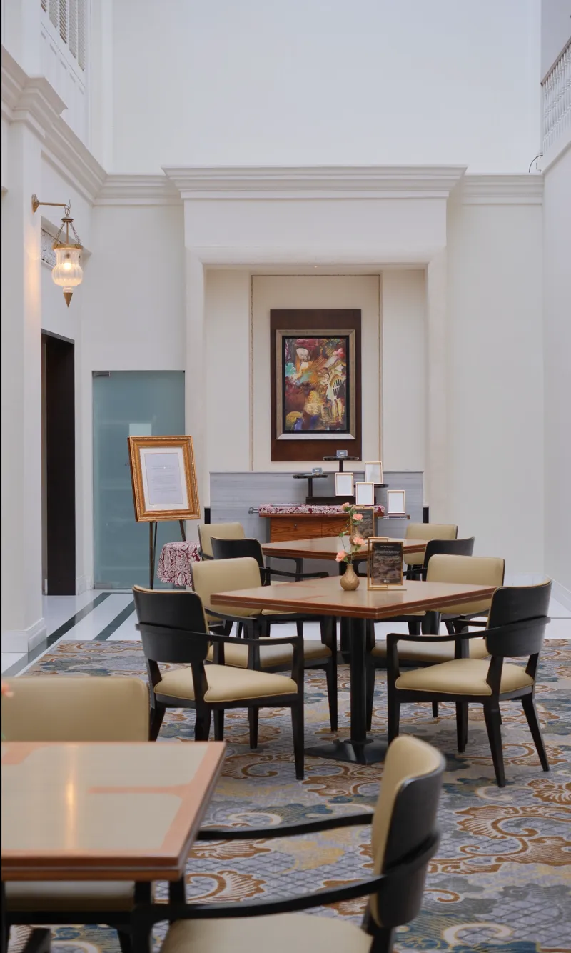 A serviced apartment or hotel lobby interior with high ceilings, the kind of temporary base people land in during their first weeks in Singapore